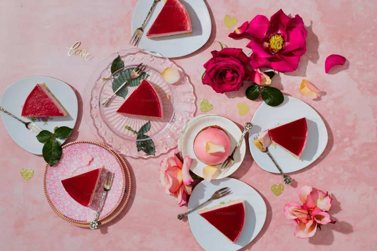 beside a bottle of rosé wine and a glass filled with pink liquid on a gray surface.